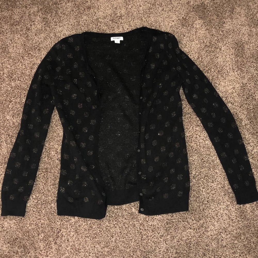 Black cardigan with polka dots.